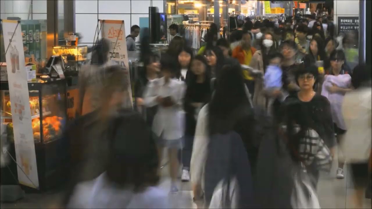 사람들이 지하철 역 안에서 빠르게 움직이는 모습을 장노출로 담은 사진